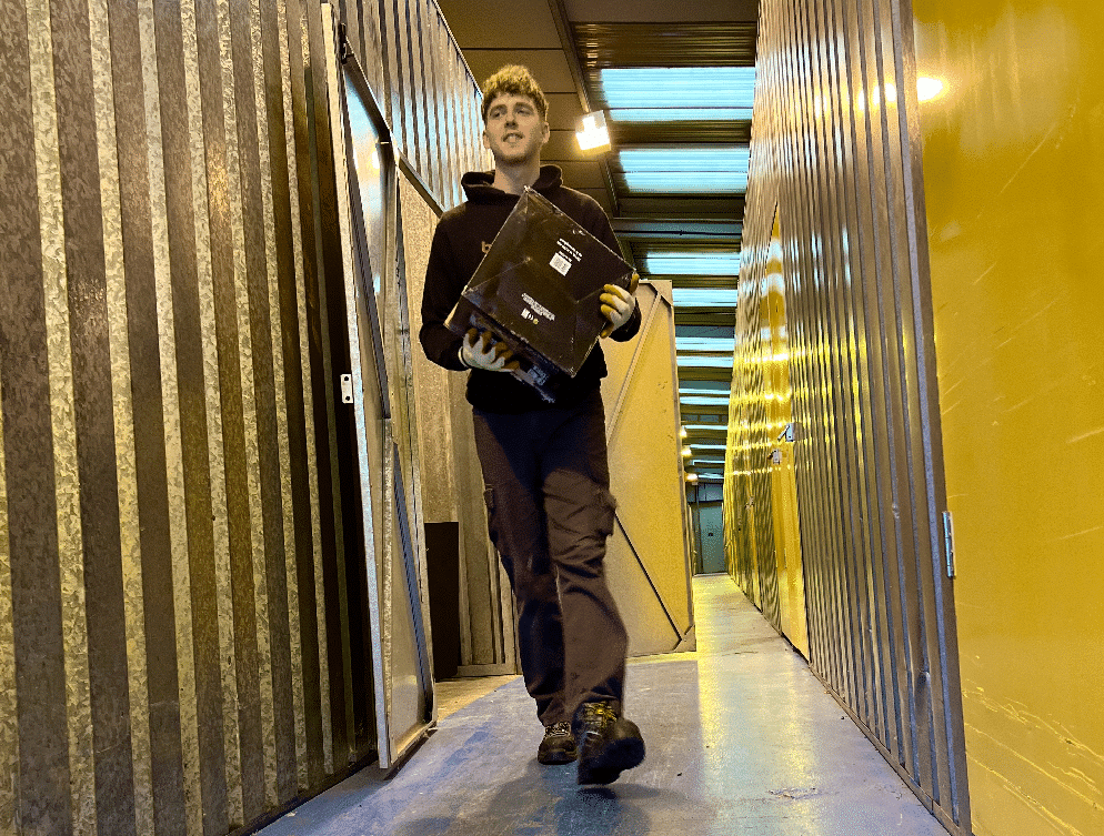 A crew member carrying a box inside the dry, brick-built Bellwoods storage warehouse near Huddersfield